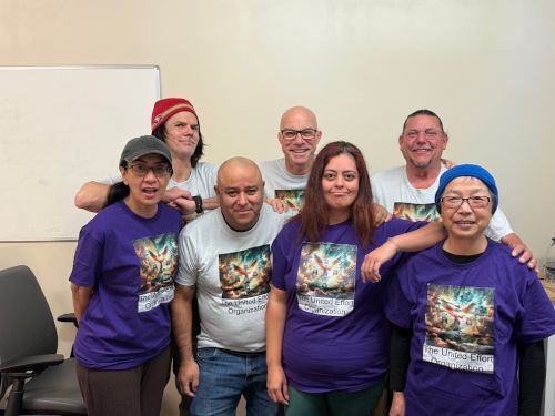 A group of seven people wearing matching shirts that say Charlie's Angels on them.